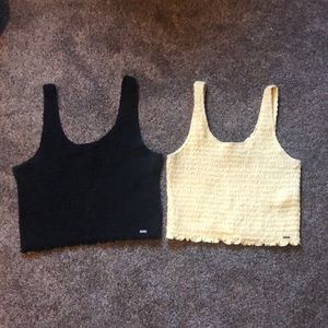 2 Hollister tank tops. Both size large. One is black and one is yellow.
